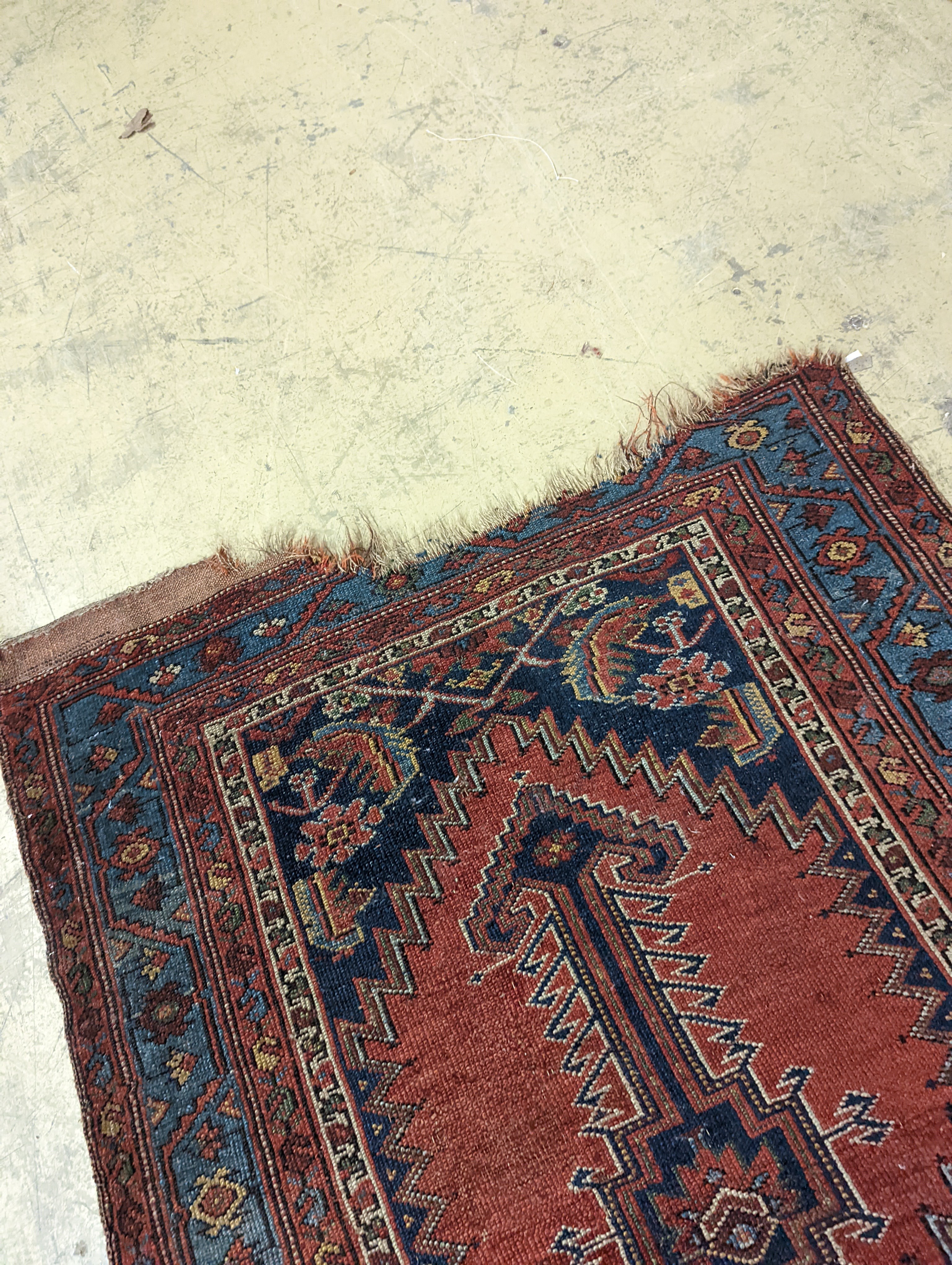 An antique Caucasian red ground runner, 380 x 100cm